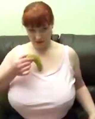 Amateur redhead plays with her tits